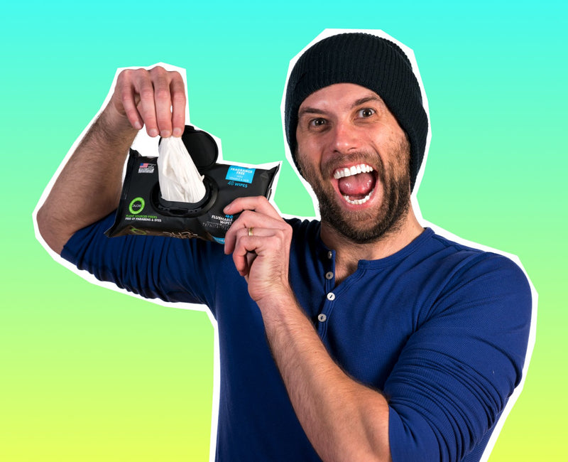 Man pulling a DUDE Wipe from a 48-pack of Fragrance Free DUDE Wipes